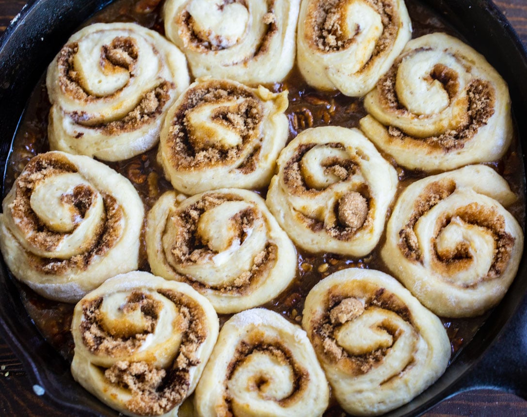 Uncooked Cinnamon Rolls in cast iron pan.
