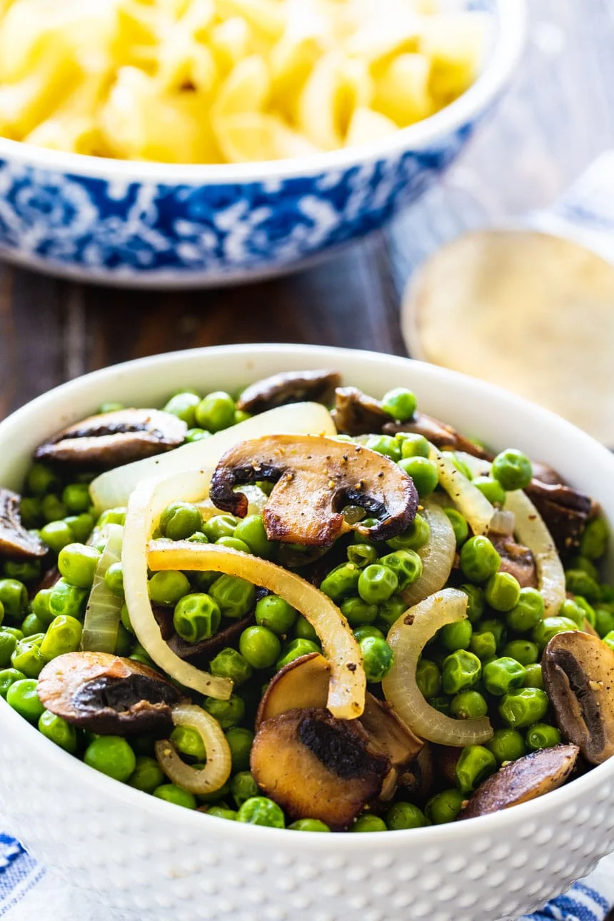 Buttered Peas with Mushrooms in a white bowl.