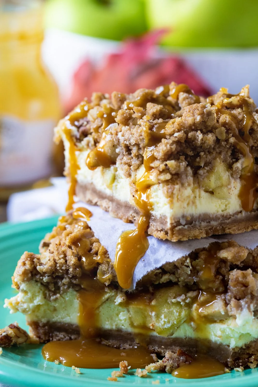 Caramel Apple Cheesecake Bars stacked on top of each other.