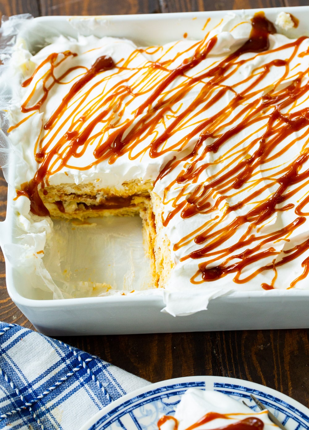 Caramel Ritz Cracker Icebox Dessert in baking dish with piece cut out.