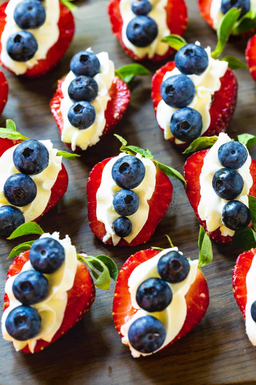 Cheesecake Stuffed Strawberries topped with blueberries.