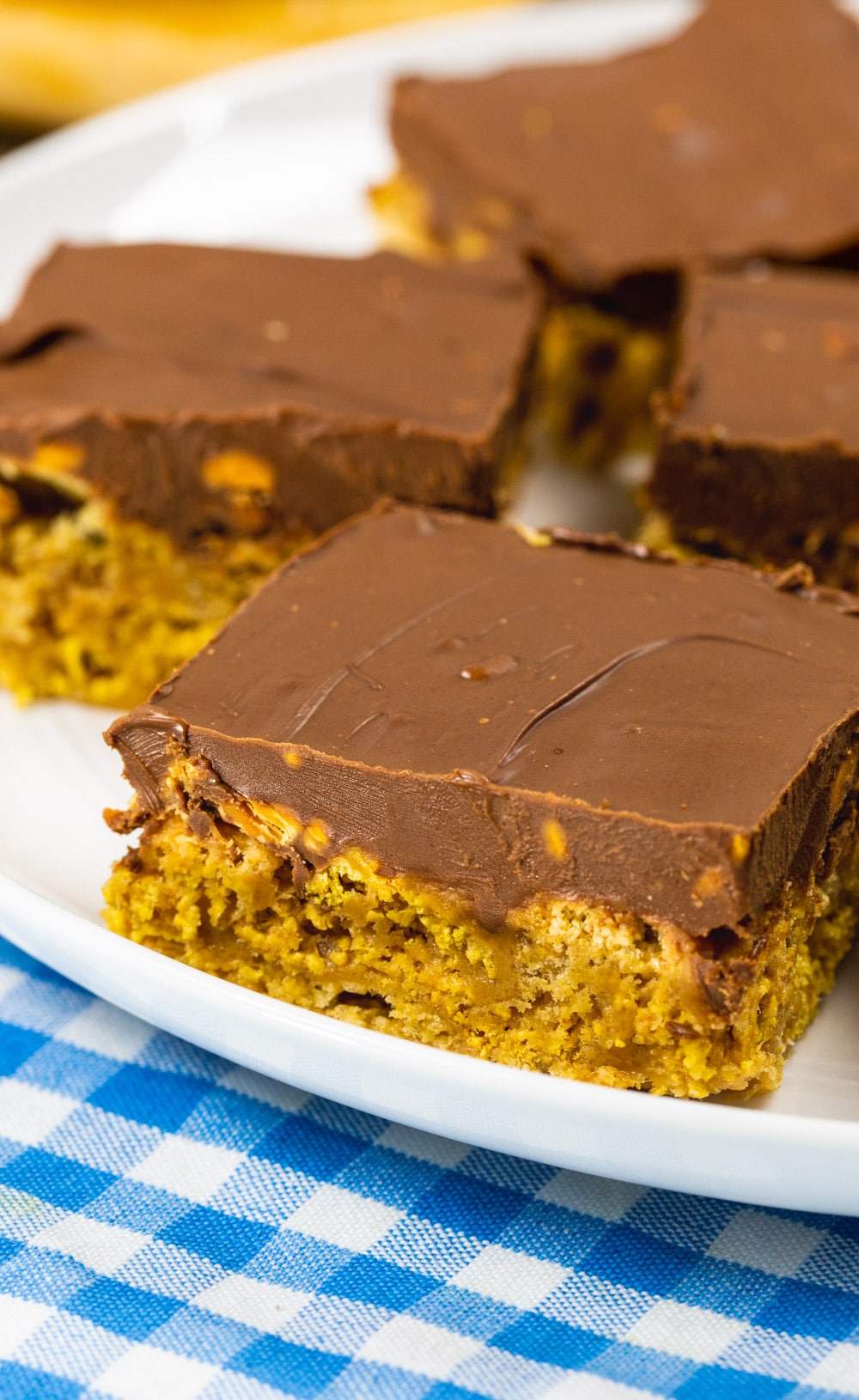 Close-up of Chex Scotcharoo with thick layer of chocolate on top.