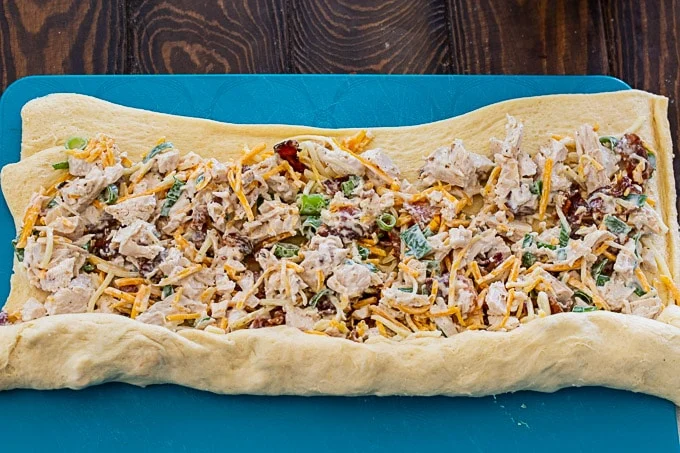 Filling spread on a sheet of crescent roll dough.
