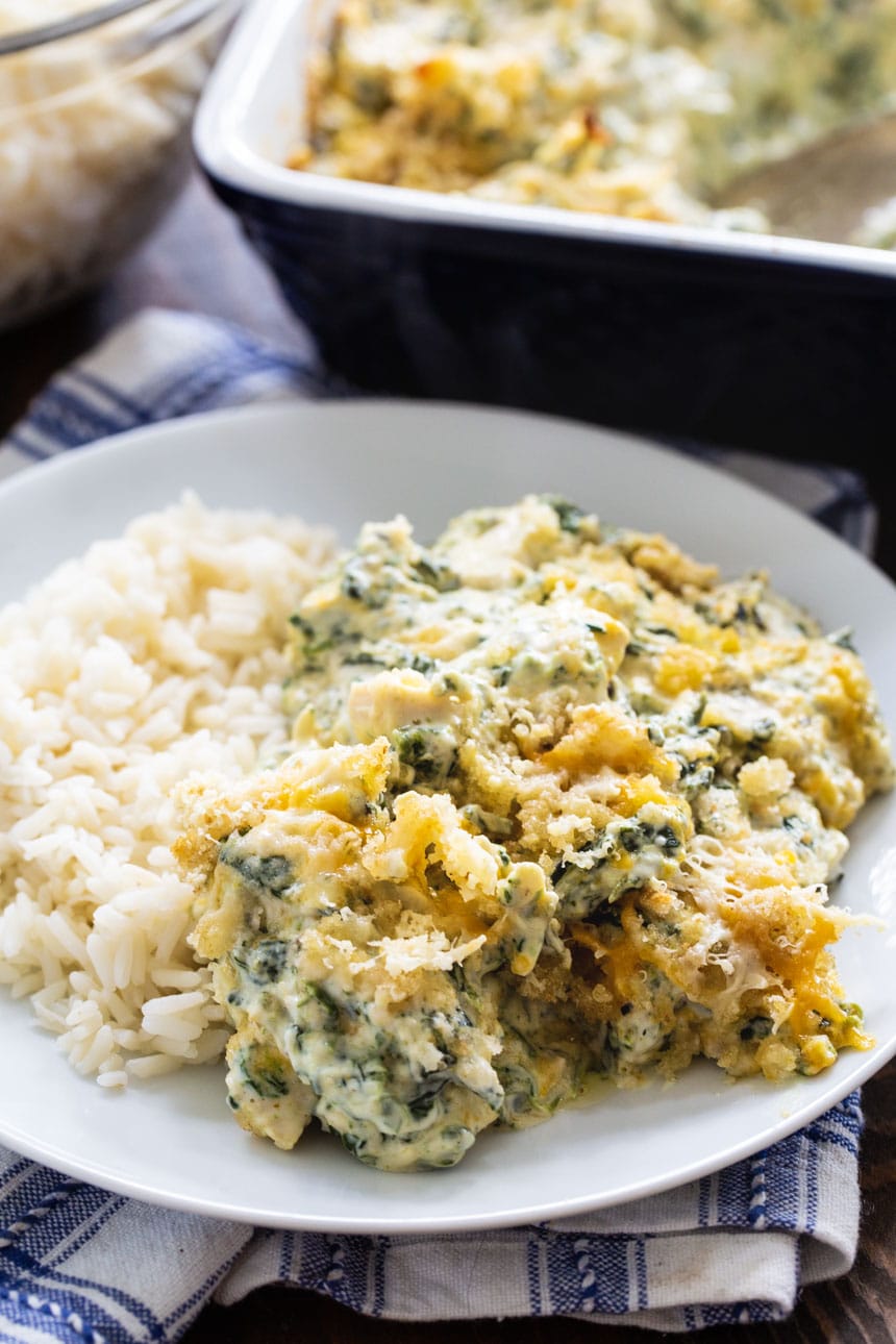 Serving of chicken casserole with spinach on a plate.