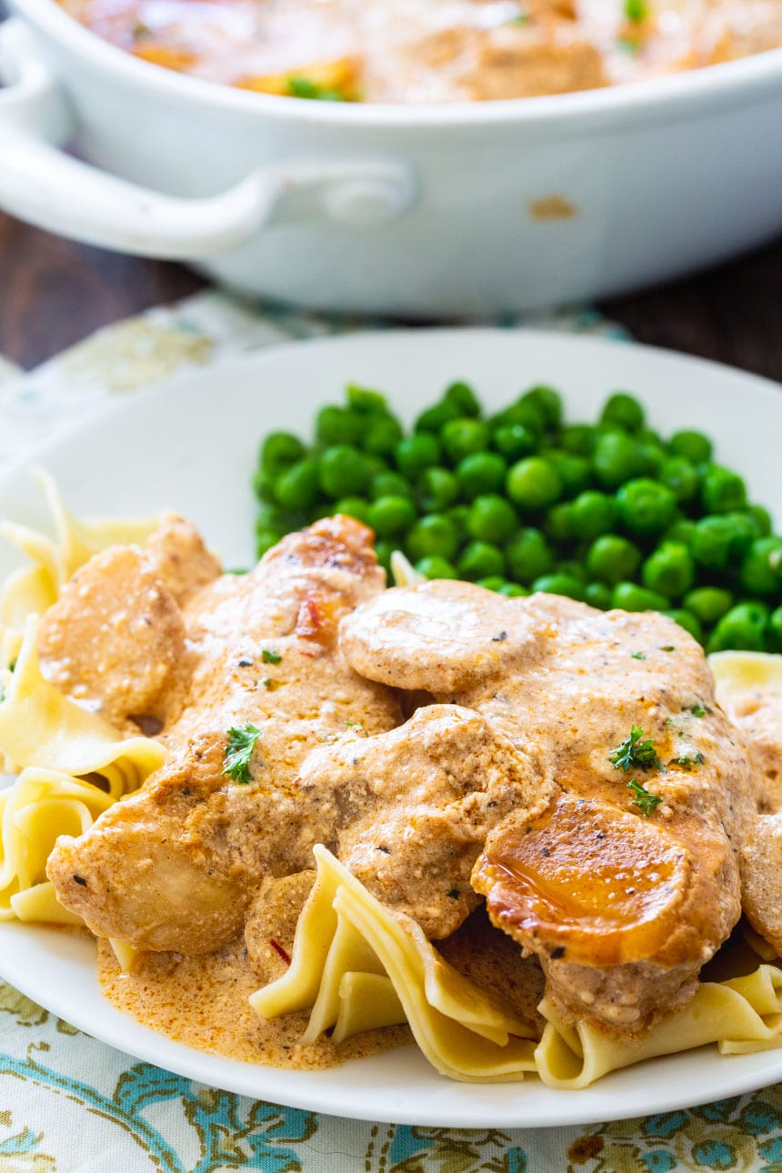 Chicken Paprikash served over egg noodles with peas.