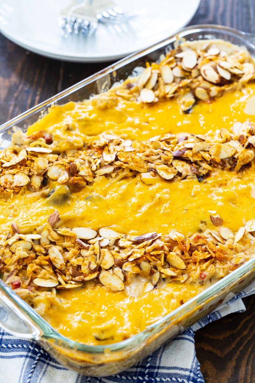 Chicken Tetrazzini topped with almonds and cheese in a 9x13-inch baking dish.