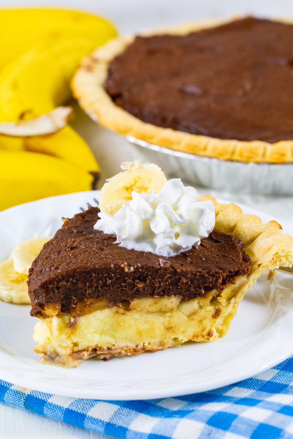 Slice of Banana Cream Pie with Chocolate on a plate.