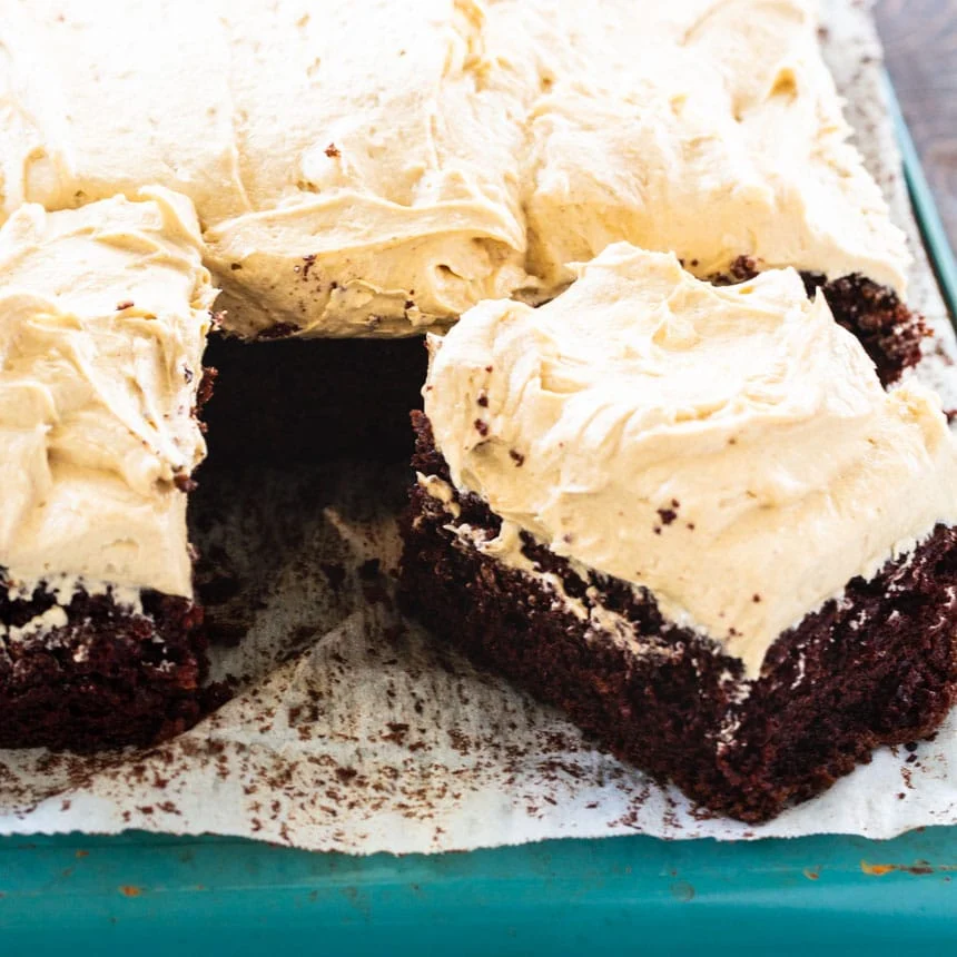 Slice of Chocolate and Peanut Butter Icing cut from rest of cake.