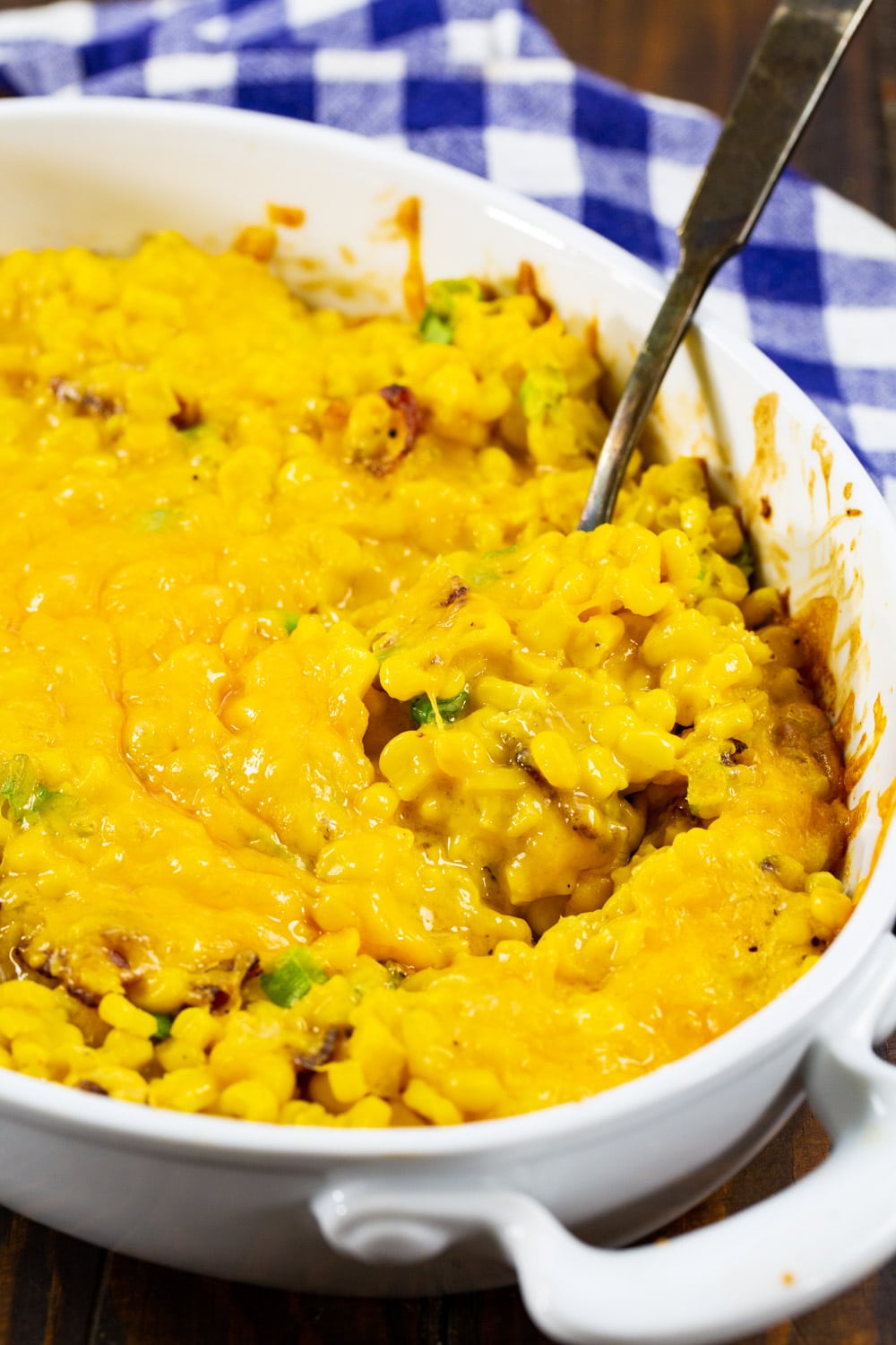 Spoon scooping up corn casserole.