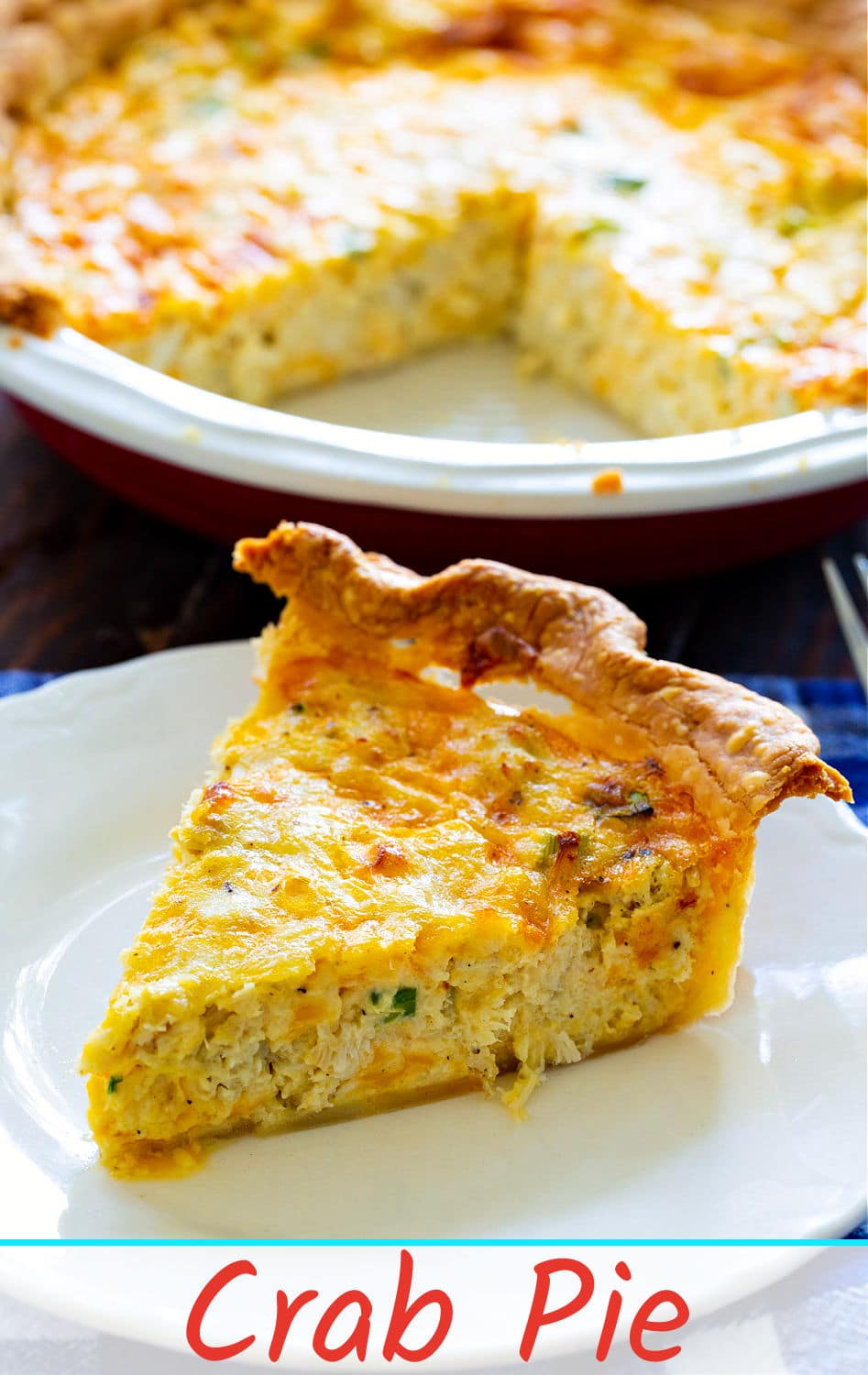 Slice of pie with crab on a plate.