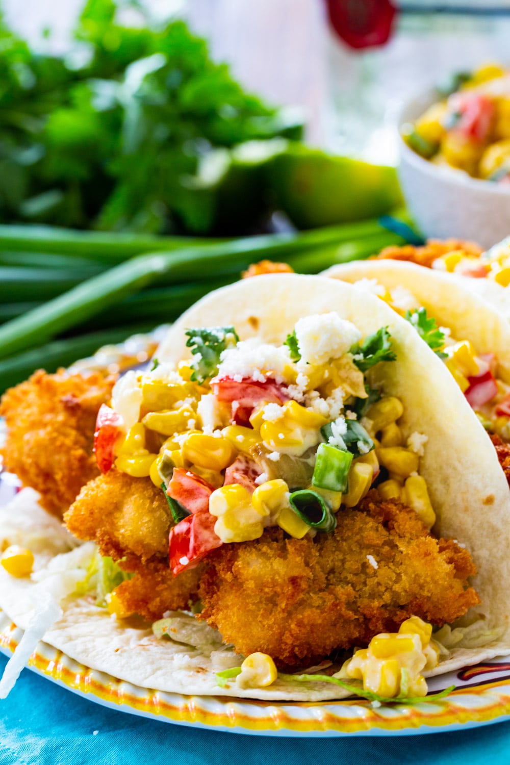 Crunchy Catfish Tacos with Tequila Creamed Corn on a plate.