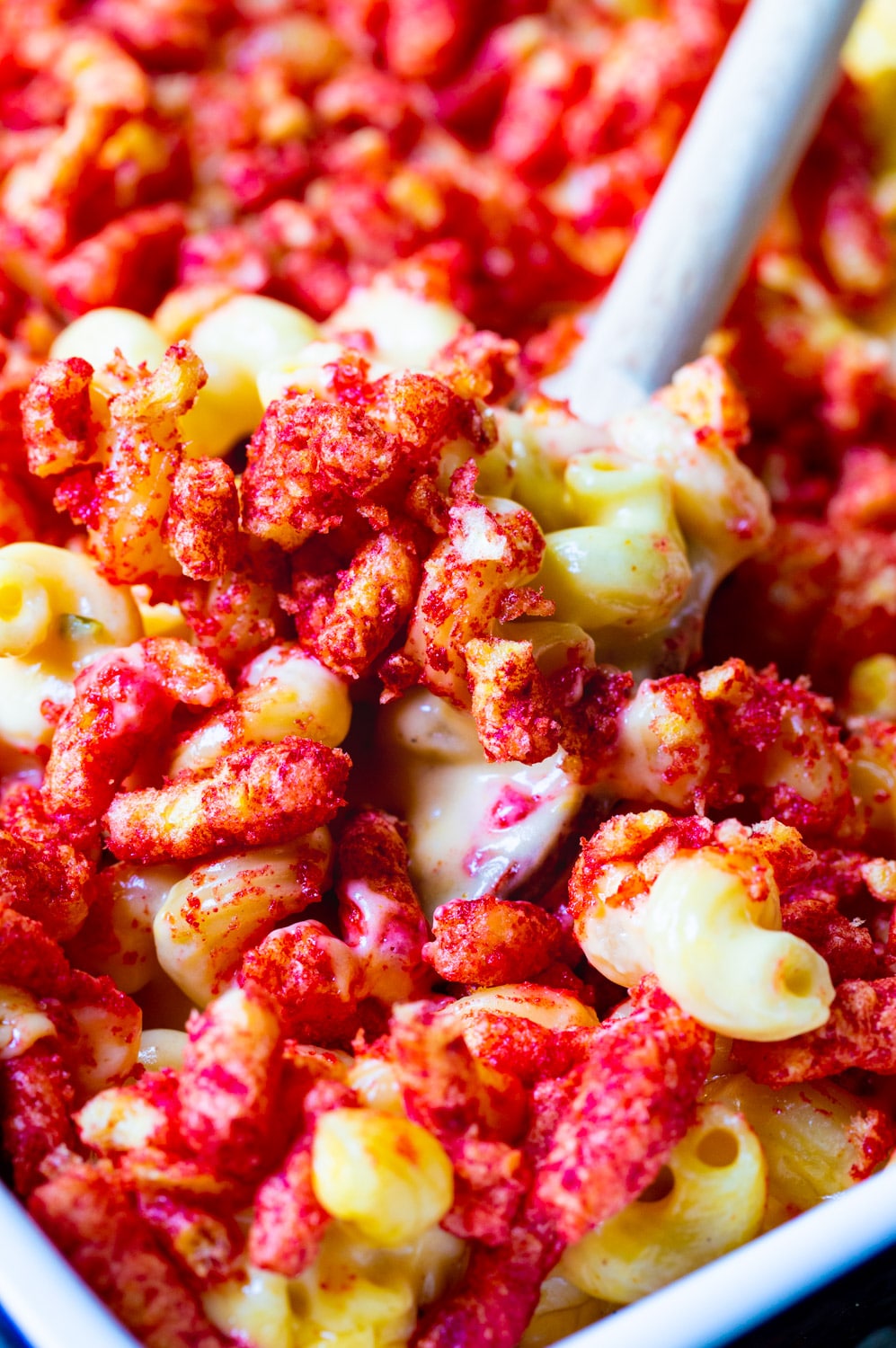 Spoon scooping Flamin Cheetos Mac and Cheese.