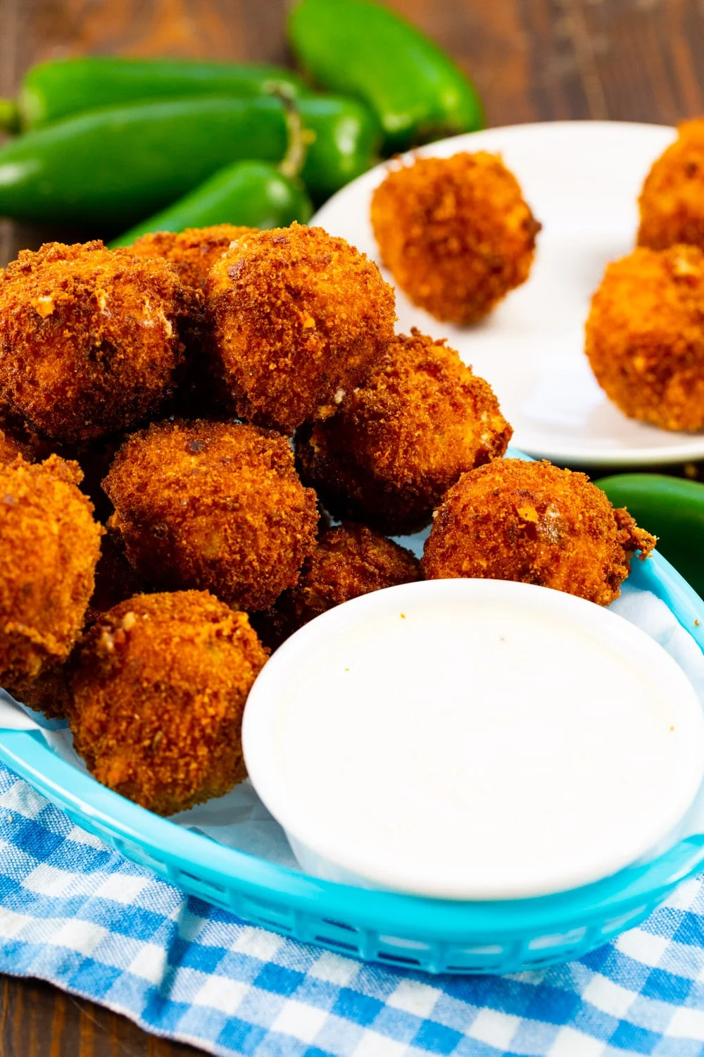 Jalapeno Popper Bites in a basket with a bowl of ranch dressing.