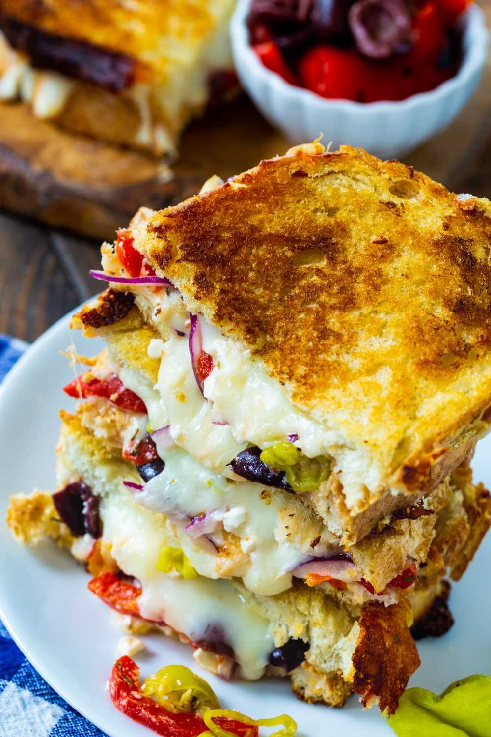 Slices of grilled cheese stacked on a plate.