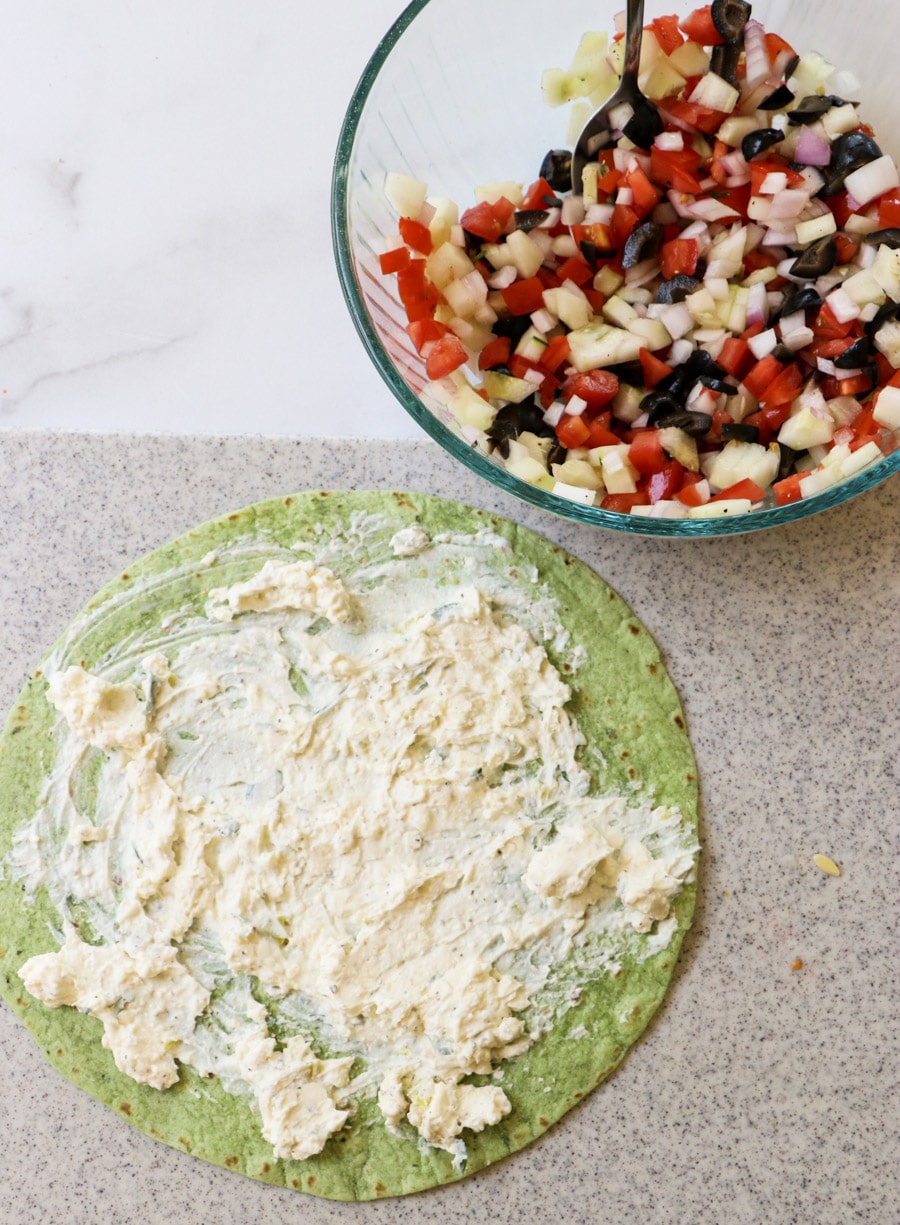 Spread cream cheese mixture on tortilla.