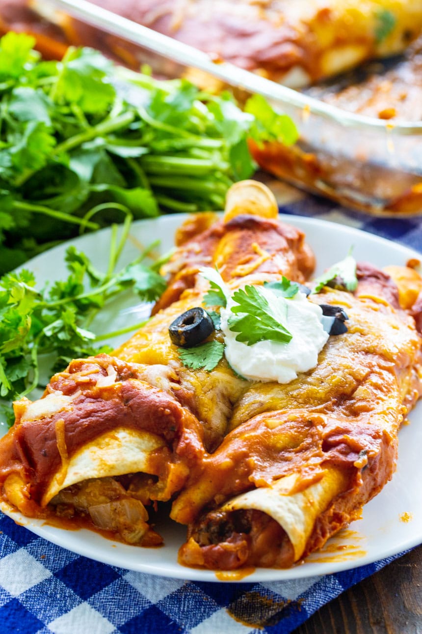 Ground Beef Enchiladas on a white plate with cilantro