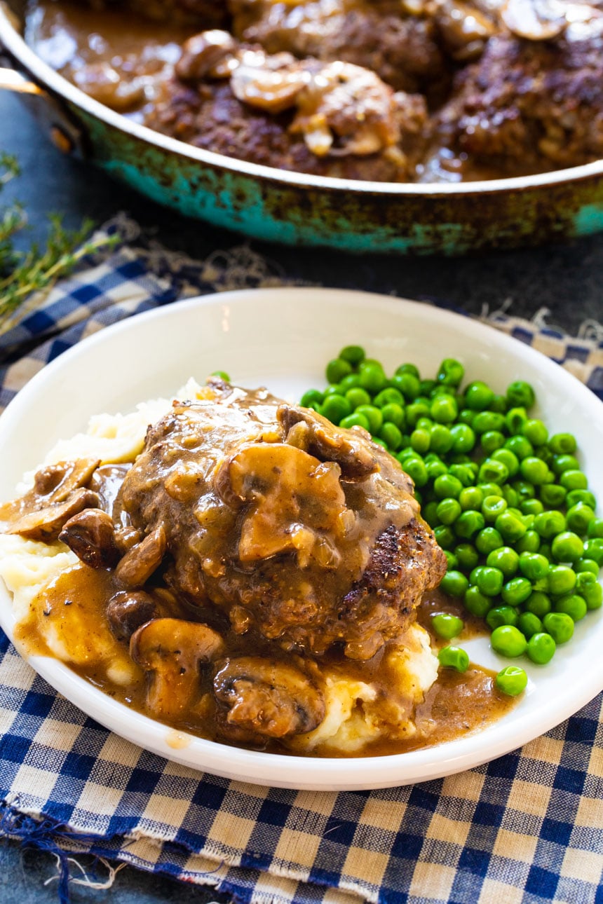 Hamburger Steak dished up on a plate.