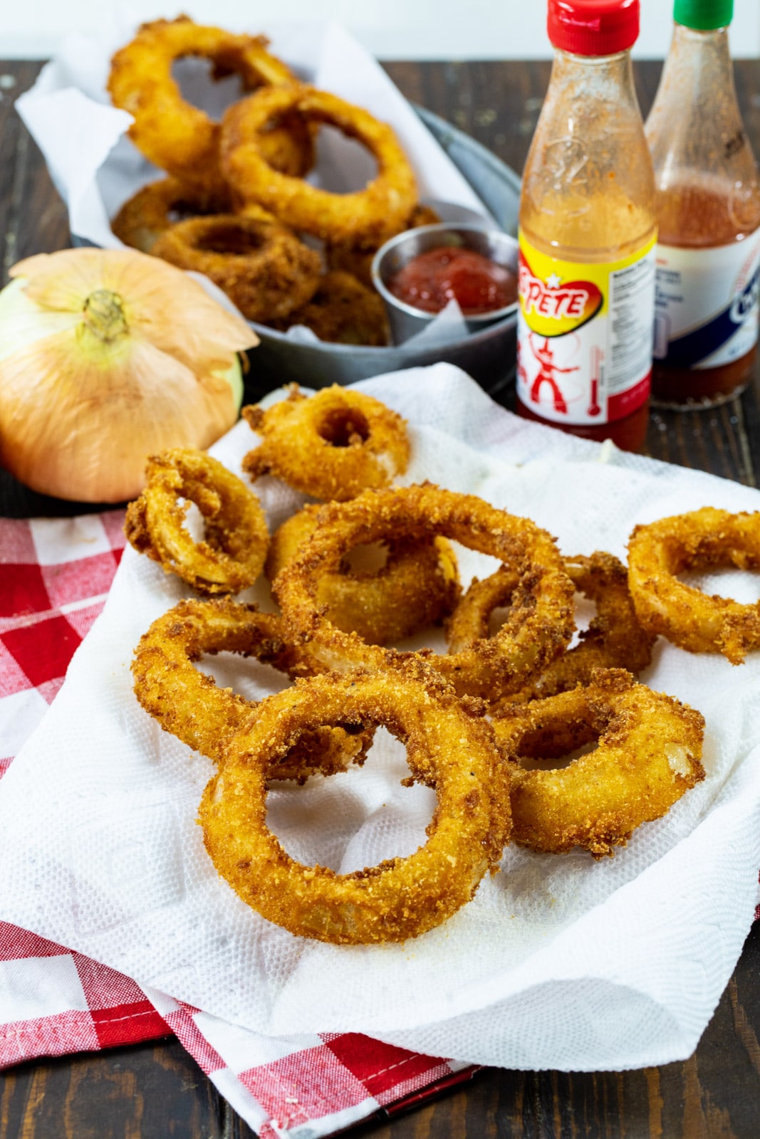 Crispy Spicy Fried Onion Rings and 2 bottles of hot sauce.