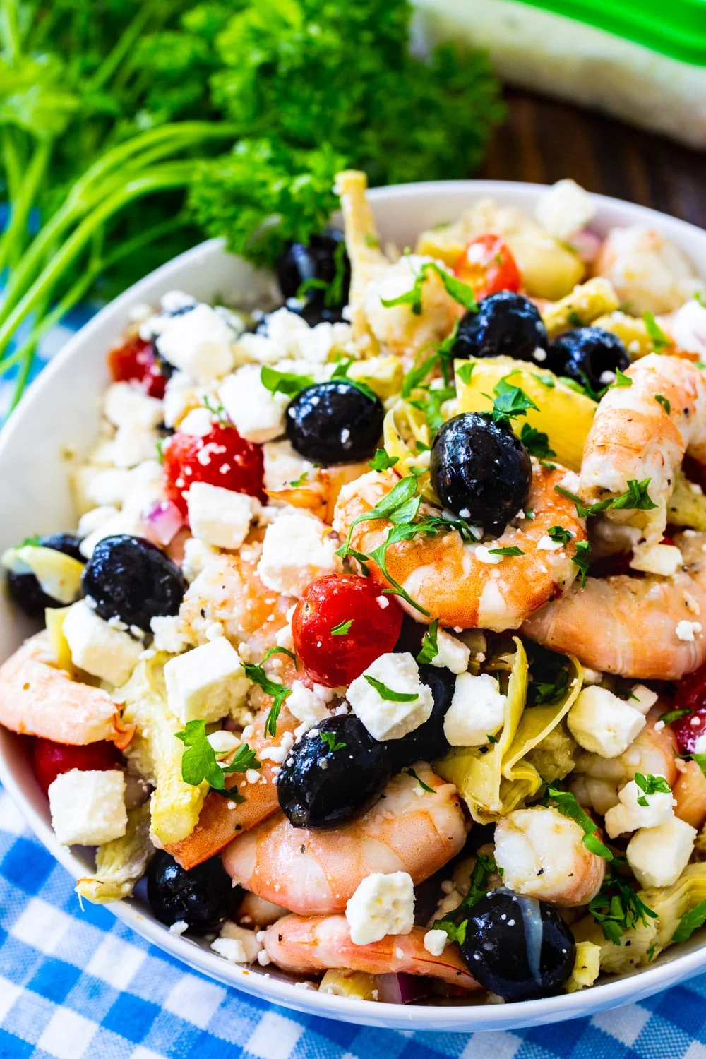 Italian Marinated Shrimp in a large bowl with fresh parlsey.
