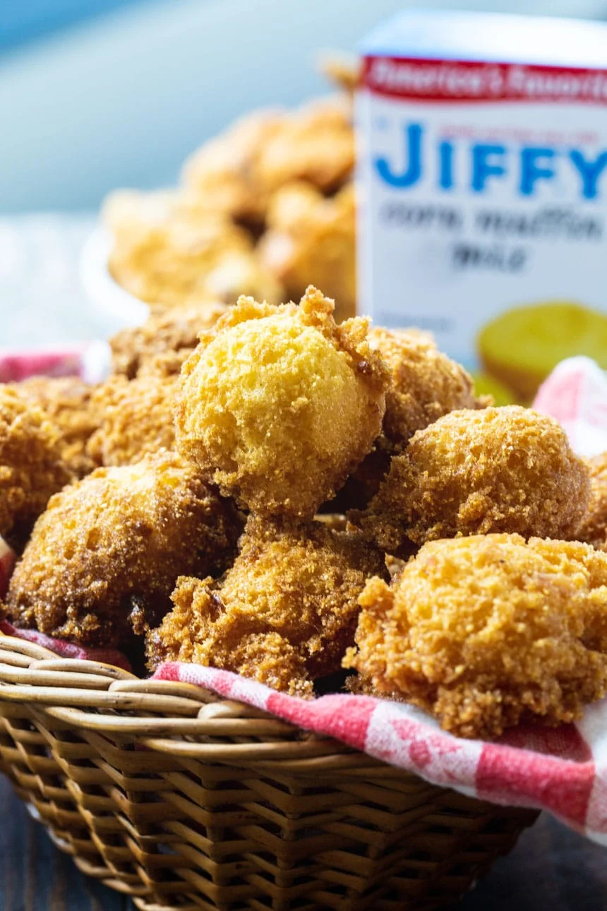 Hush Puppies in a basket with a box of Jiffy cornbread mix
