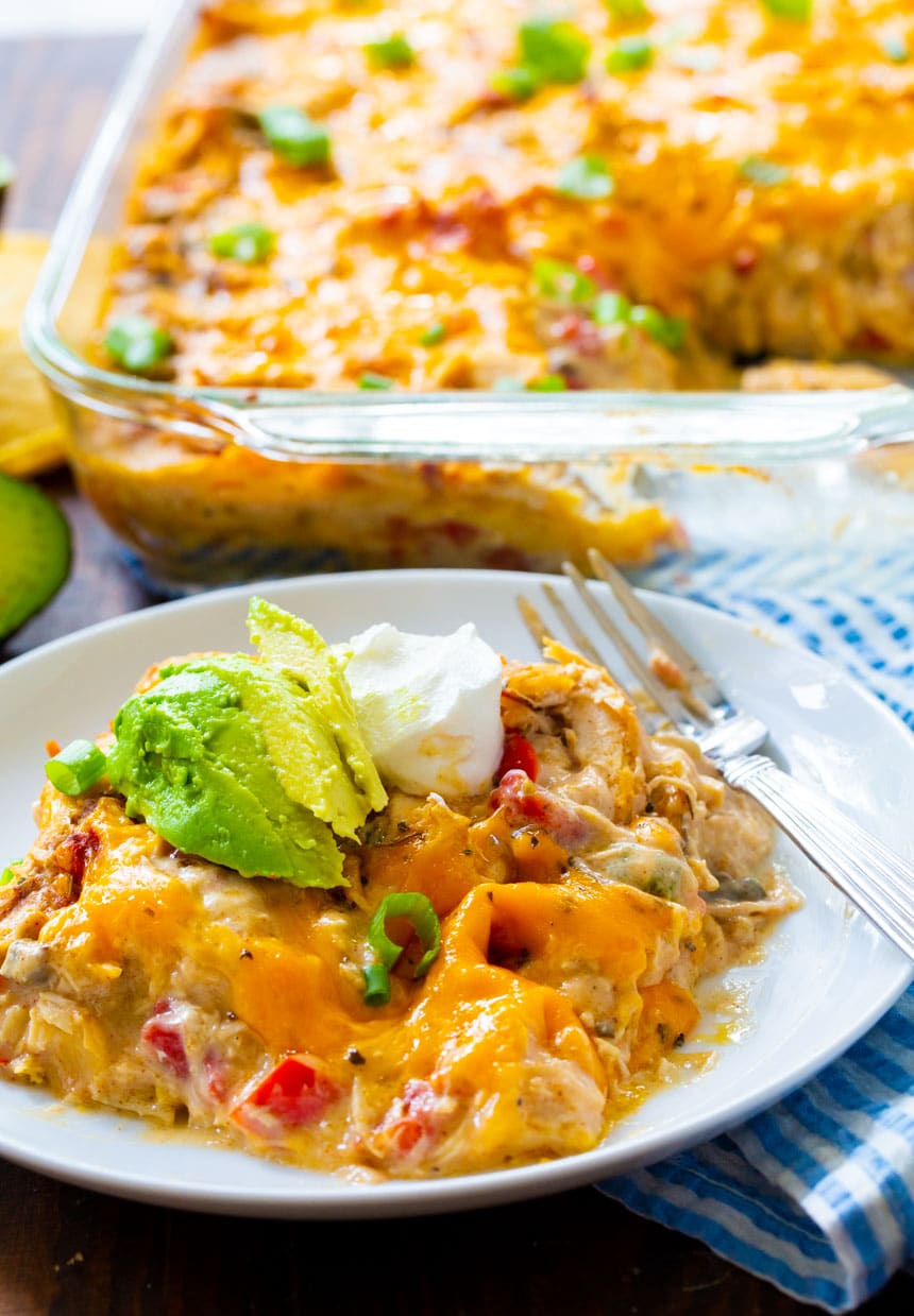 A serving of King Ranch Chicken Casserole on a plate with baking dish in background