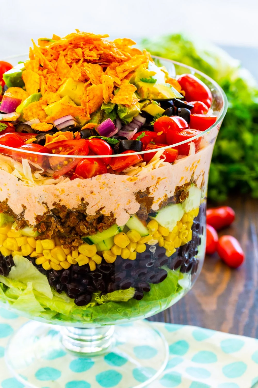 Layered Taco Salad in a trifle bowl.