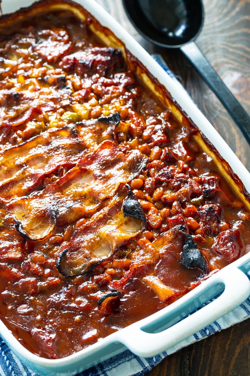 Molasses Baked Beans with Strips of bacon in a baking dish