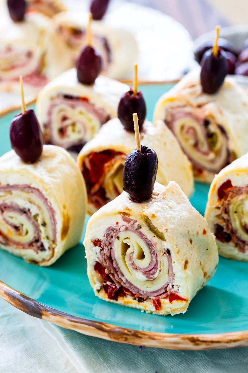 Pinwheels on a blue serving plate.