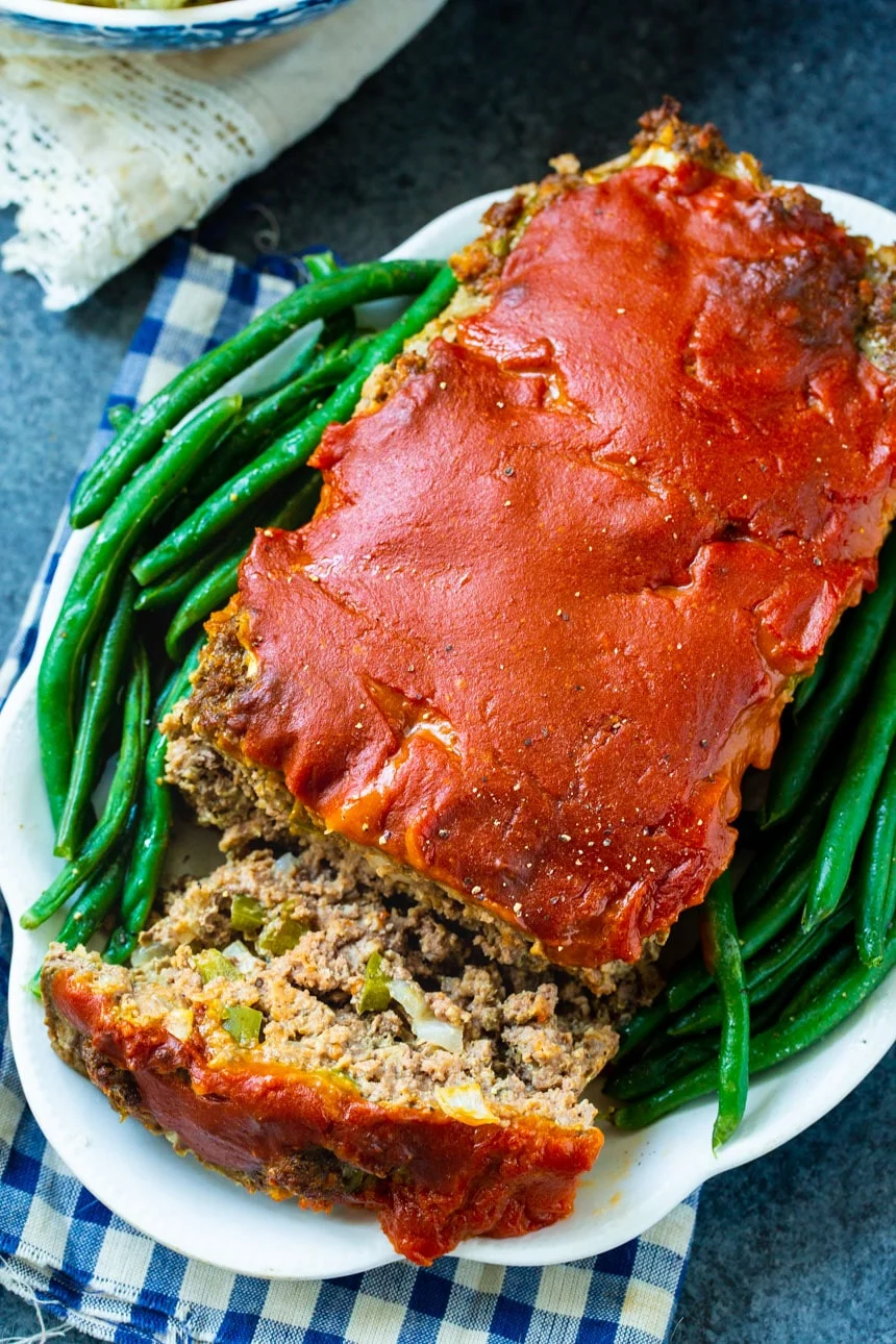 Overhead of meatloaf with one slice cut.
