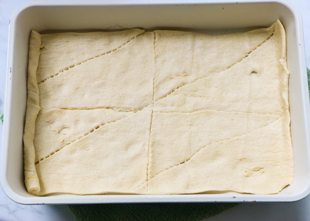 Crescent roll dough in bottom of baking dish.