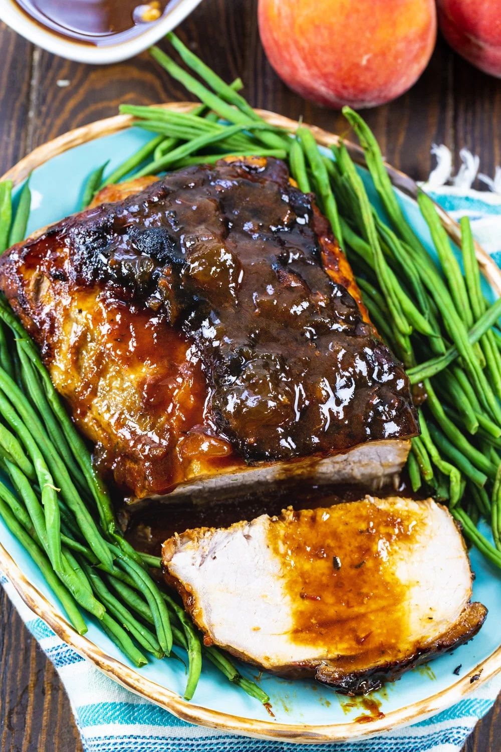 Pok Roast surrounded by green beans.