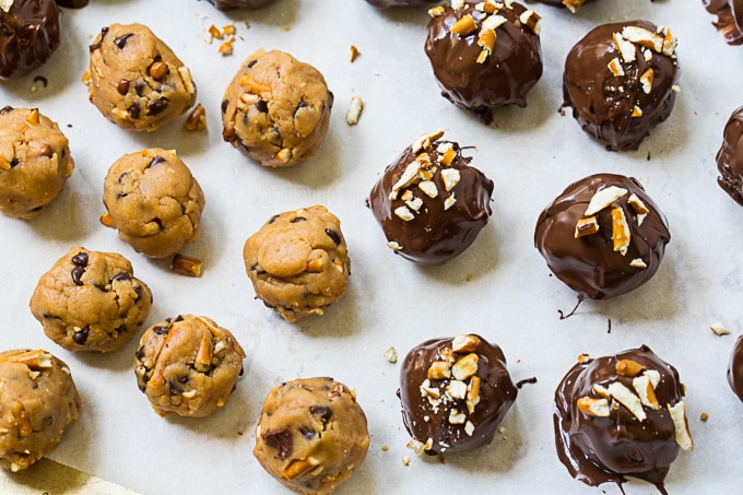 Uncoated and coated truffles on a baking sheet.