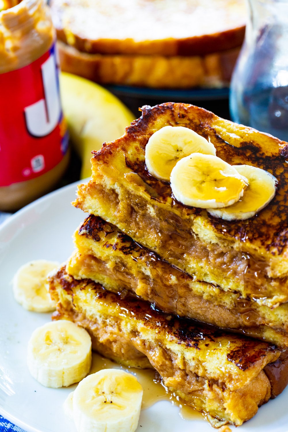 French Toast topped with banana slices on a plate.