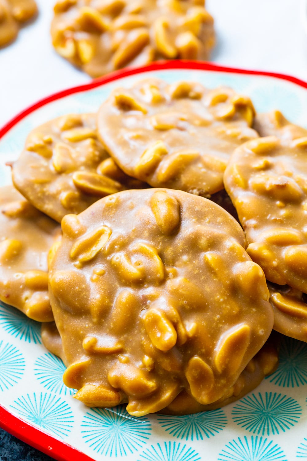 Peanut Pralines on a blue and red plate.