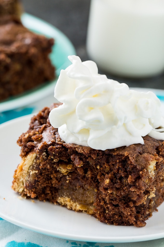 Pecan Pie Brownies topped with whipped cream.