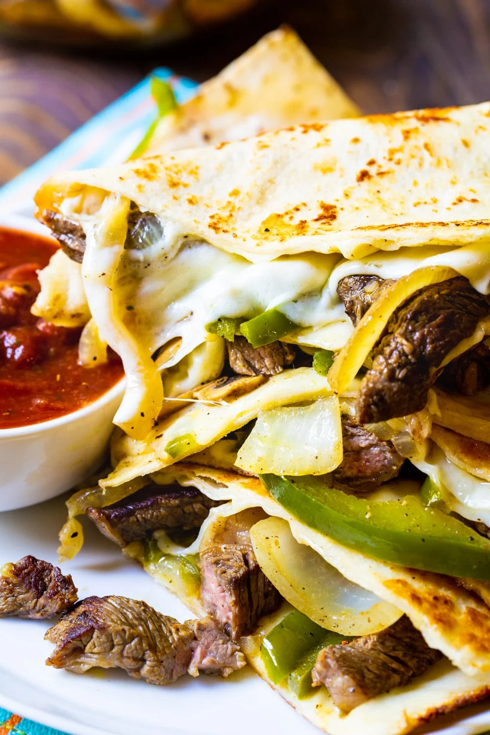 Philly Cheese Steak Quesadillas on a plate with salsa.