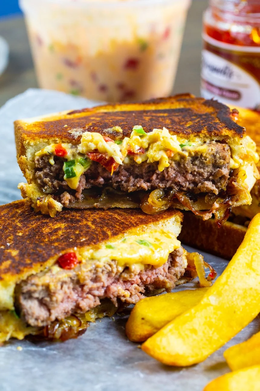 Pimento Cheese Patty Melt cut in half with fries.