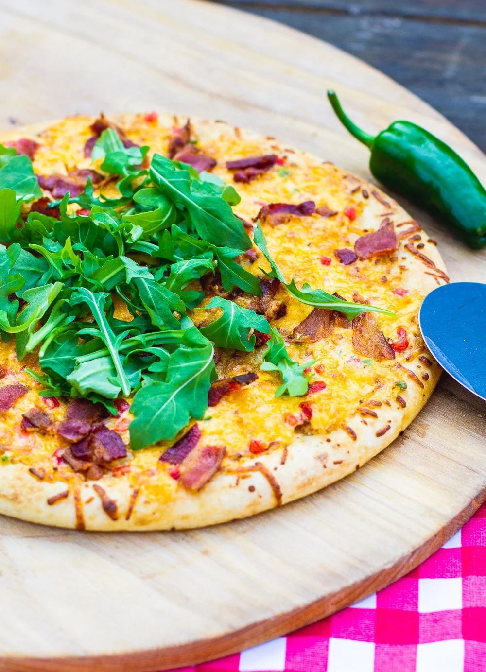 Whole pizza on a pizza peel.