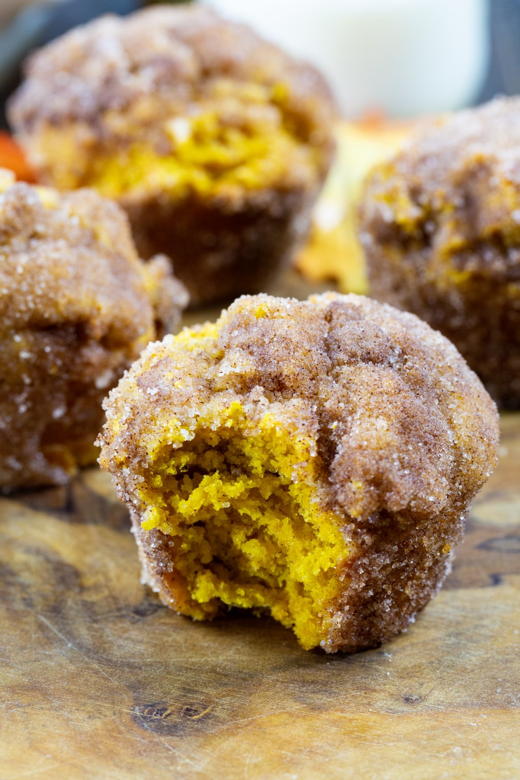Pumpkin Doughnut Muffins on a wood serving board.