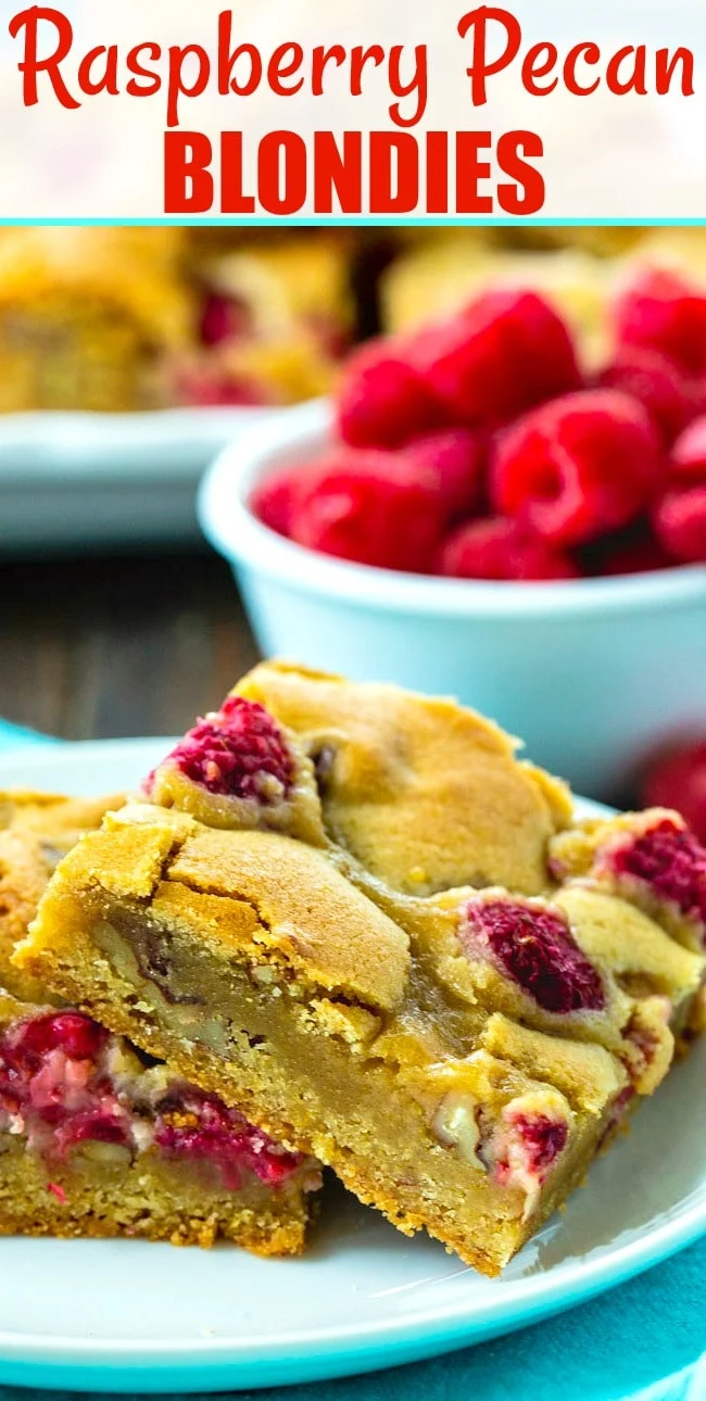 Two bars on a plate with bowl of raspberries in the background.