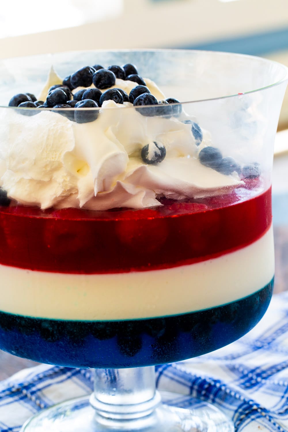 Layered jello salad in a trifle dish.