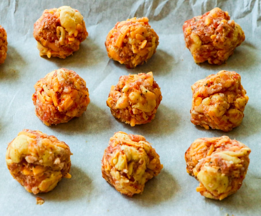 Uncooked Sausage Balls on parchment paper.