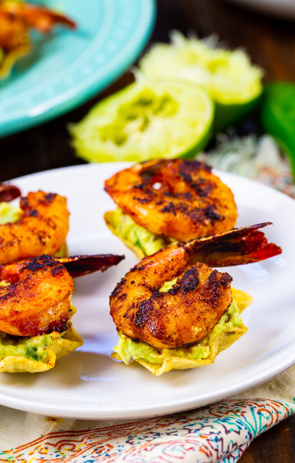 Tostada Bites topped with shrimp on a plate.