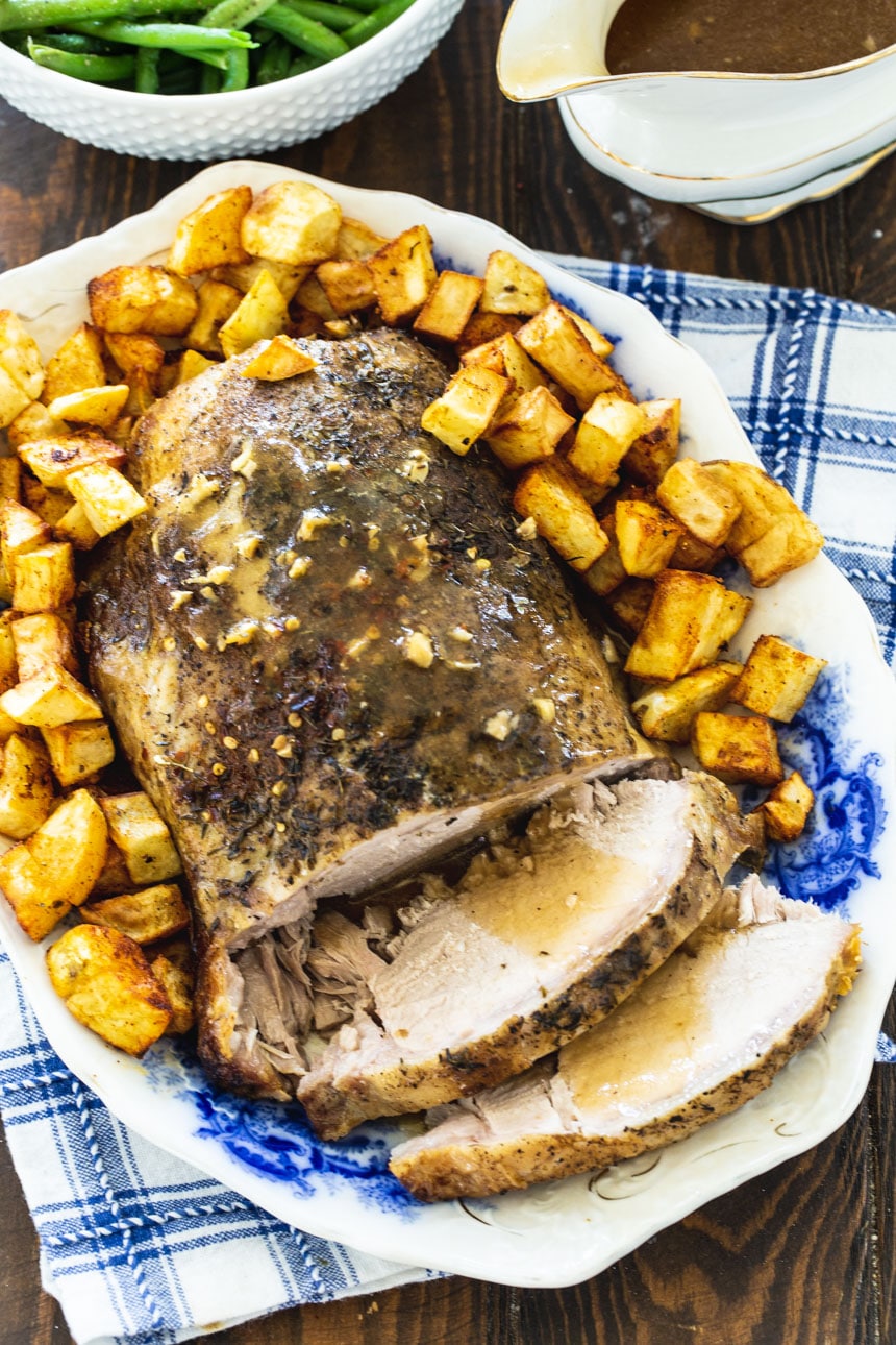 Garlic Butter Pork Loin on a platte with slices cut.