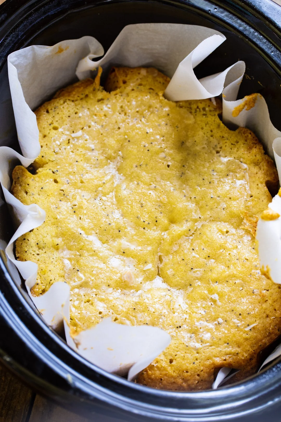 Lemon Cake in slow cooker lined with parchment paper.