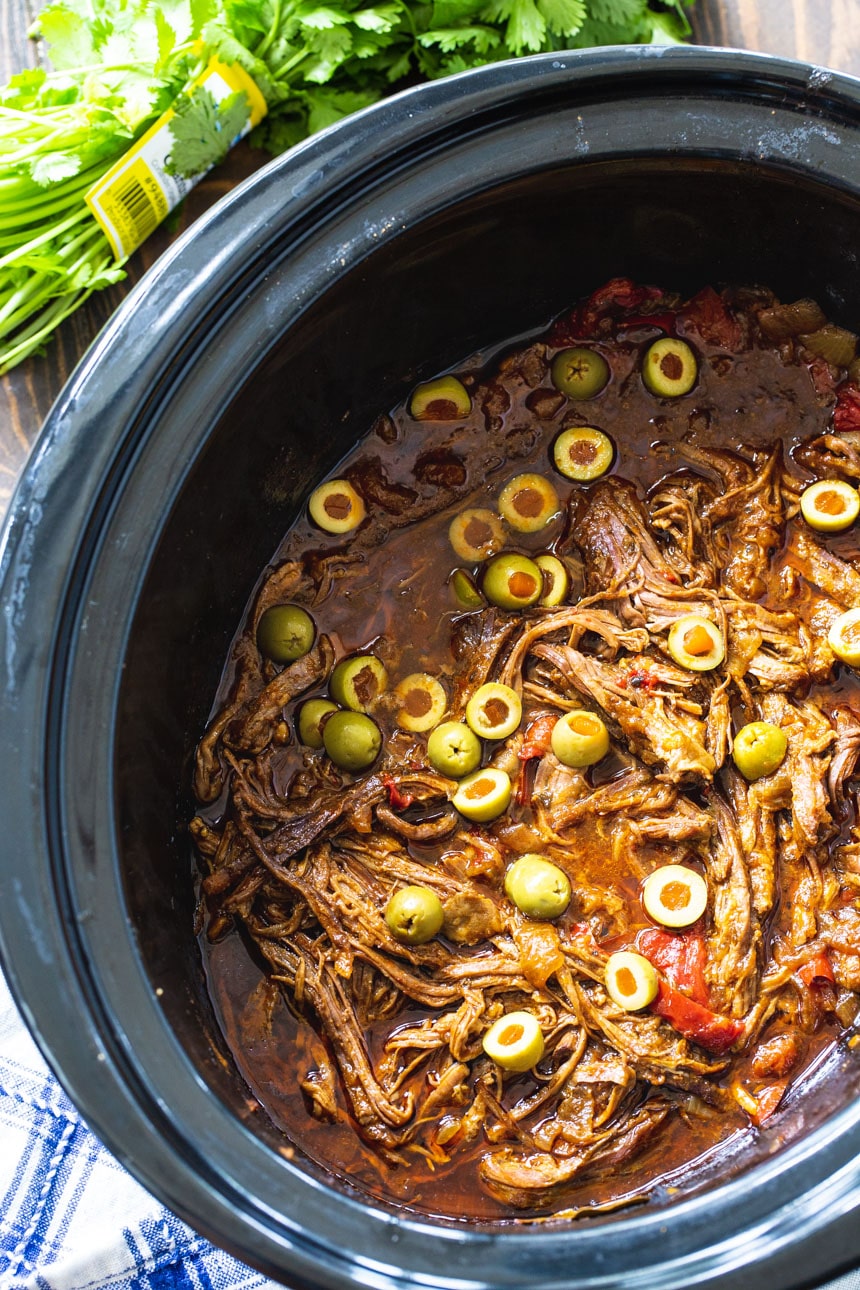 Ropa Vieja in a black crock pot.
