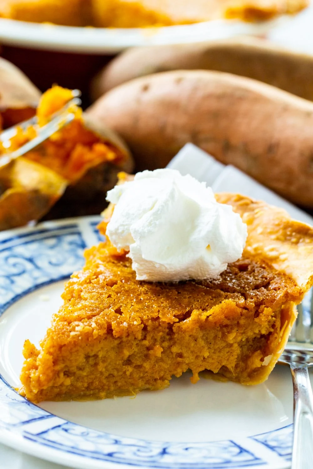 Southern Sweet Potato Pie slice topped with whipped cream.