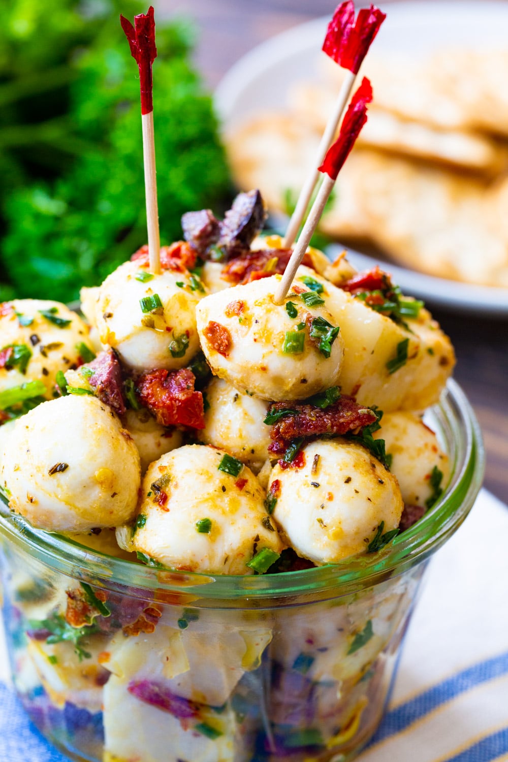Marinated Mozzarella Balls with toothicks stuck in them.