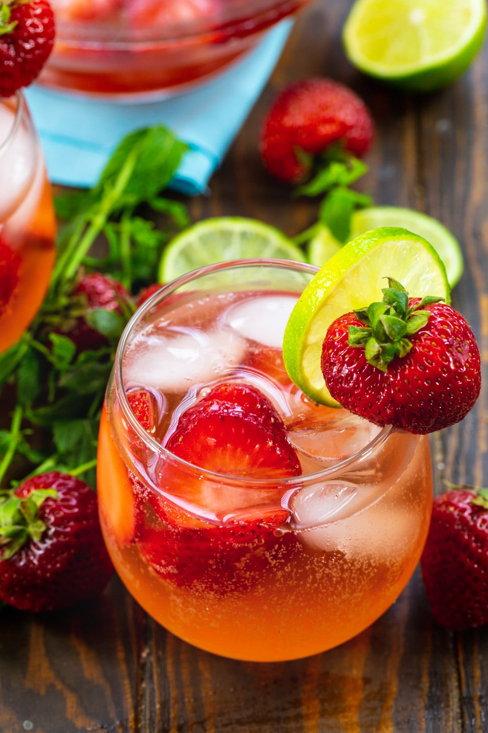 Strawberry Shortcake Sangria in a wine glass with lime slice and fresh strawberry.