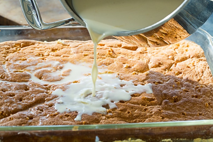 Pour the milk mixture over the tres leches cake